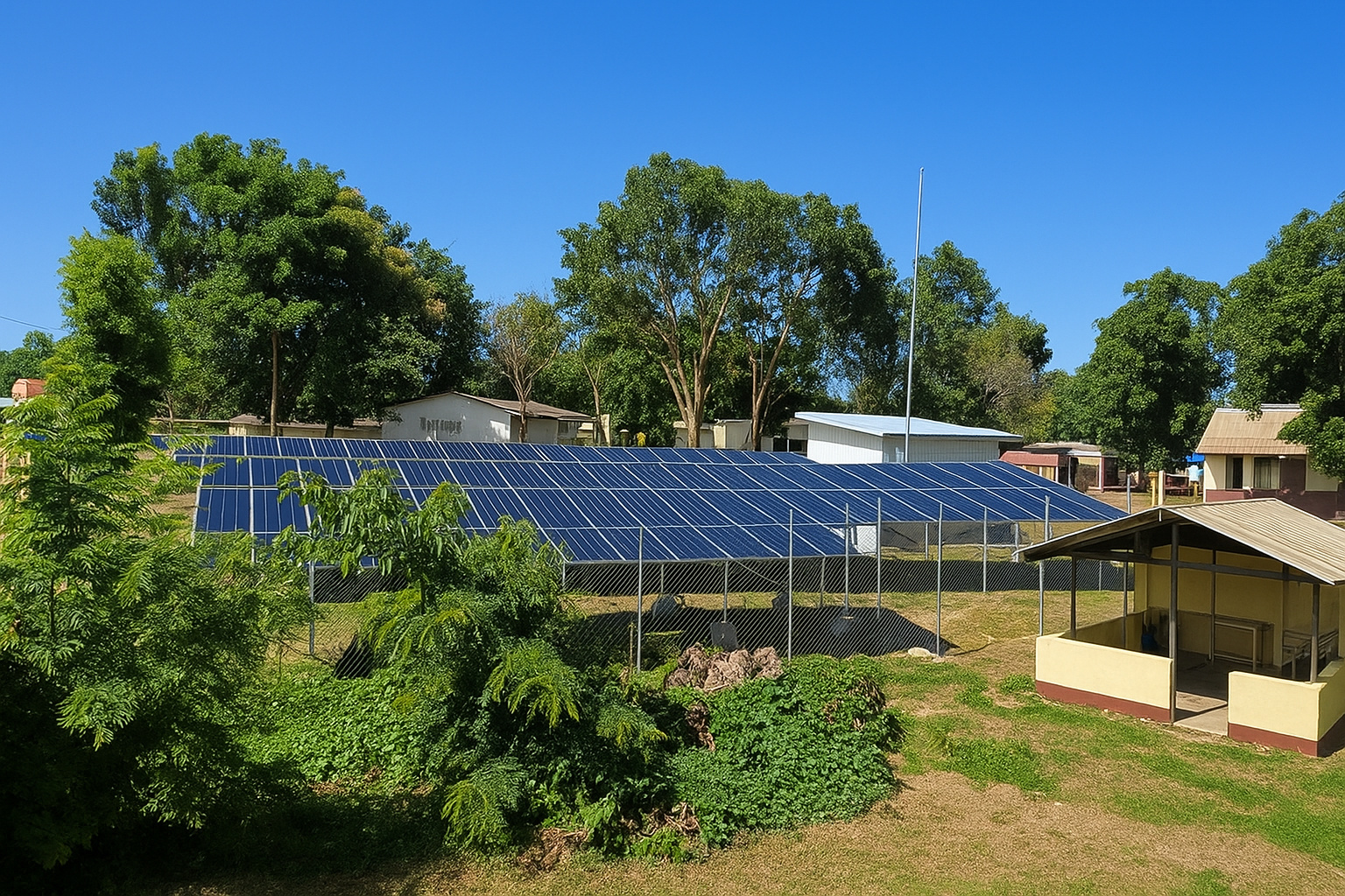 Painéis solares instalados em uma área rural com céu limpo e árvores ao redor, em um dia ensolarado.