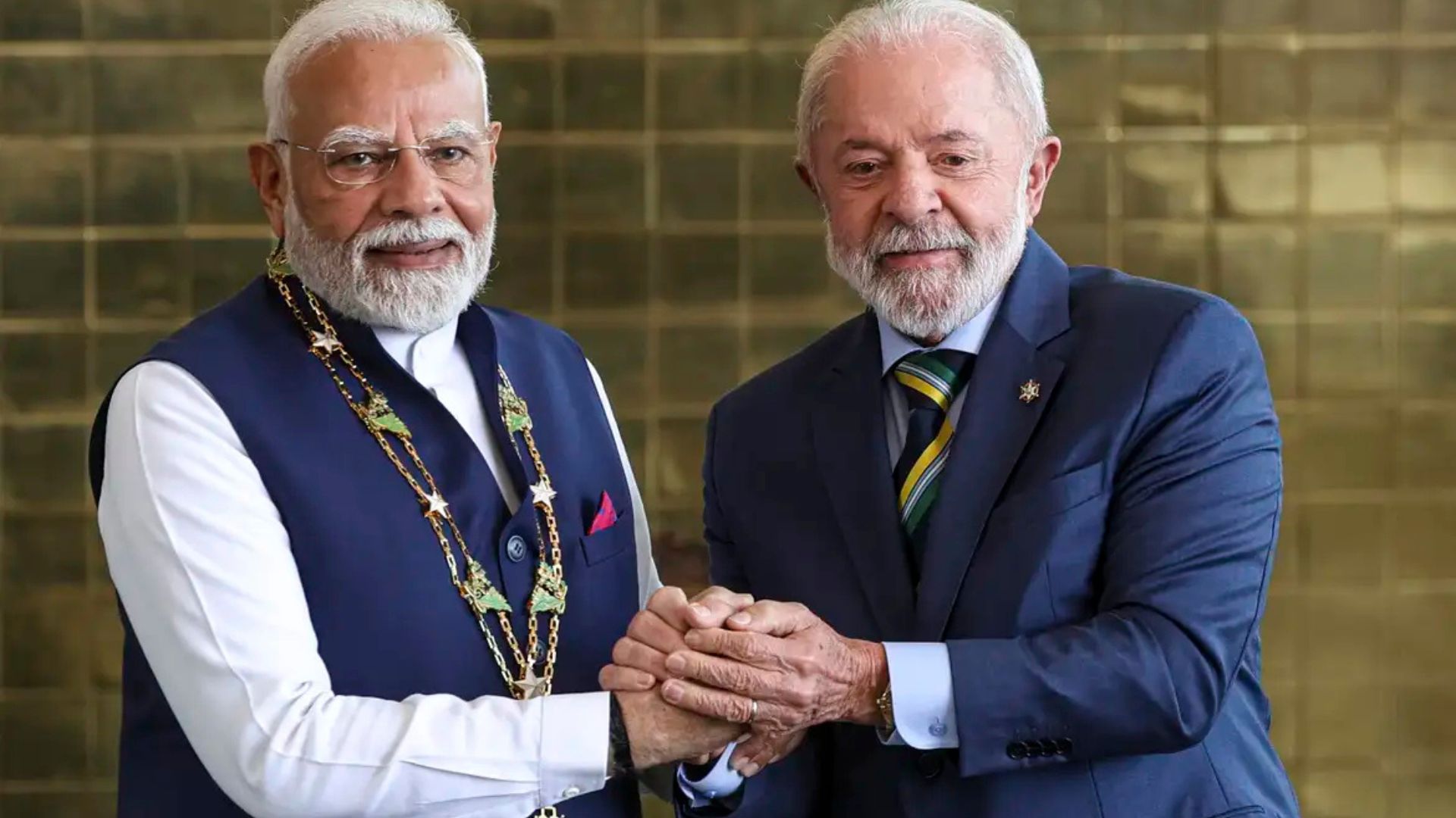 Presidente do Brasil e primeiro-ministro da Índia apertam as mãos durante encontro diplomático, simbolizando cooperação estratégica entre os dois países em energia, comércio e biocombustíveis.