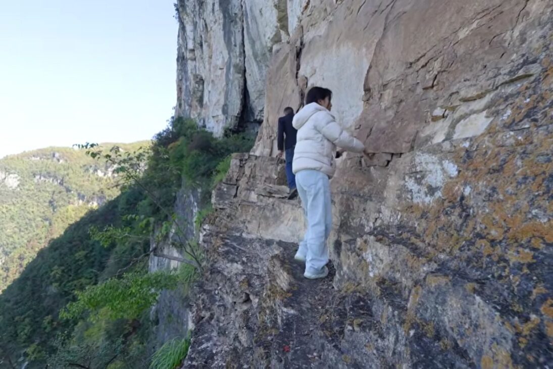 homem na China abre trilha panorâmica de cinco quilômetros em penhasco e transforma paisagem isolada com trabalho manual.