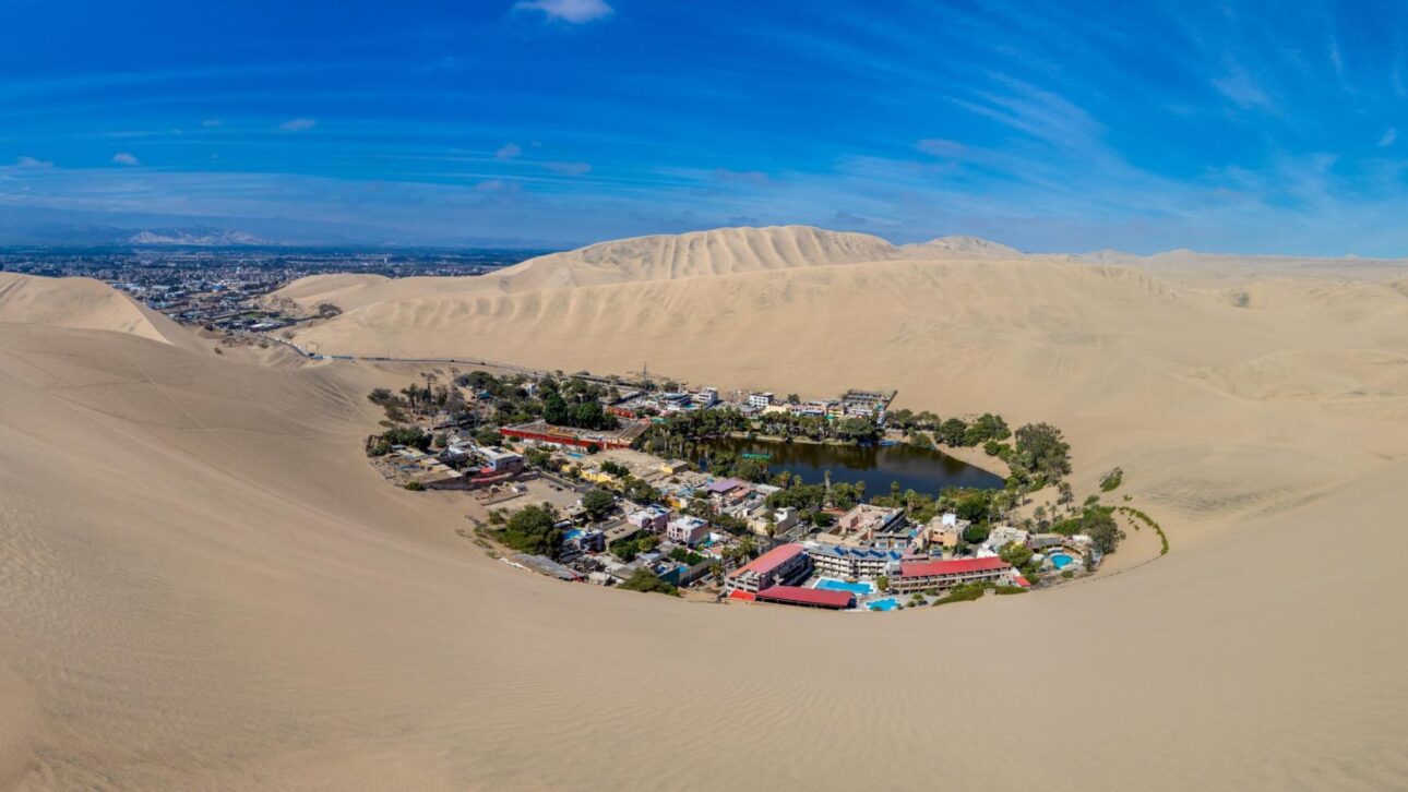 Descubra Huacachina, oásis no deserto do Peru com lagoa esmeralda, dunas gigantes e lenda misteriosa a 300 km de Lima.