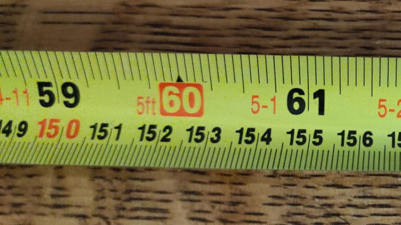 The red numbers on the tape measure mark the 16-inch spacing used in wall studs. Understand what they are for and why they go unnoticed.