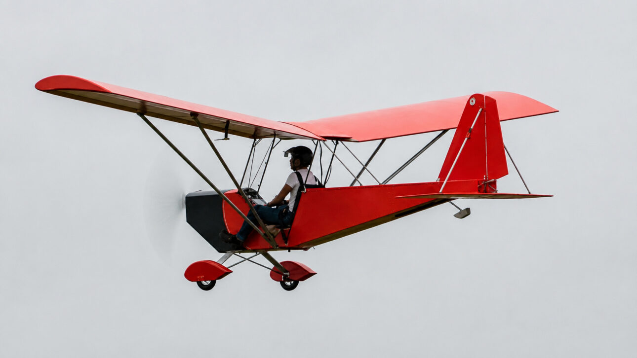 Light aircraft in flight against sky