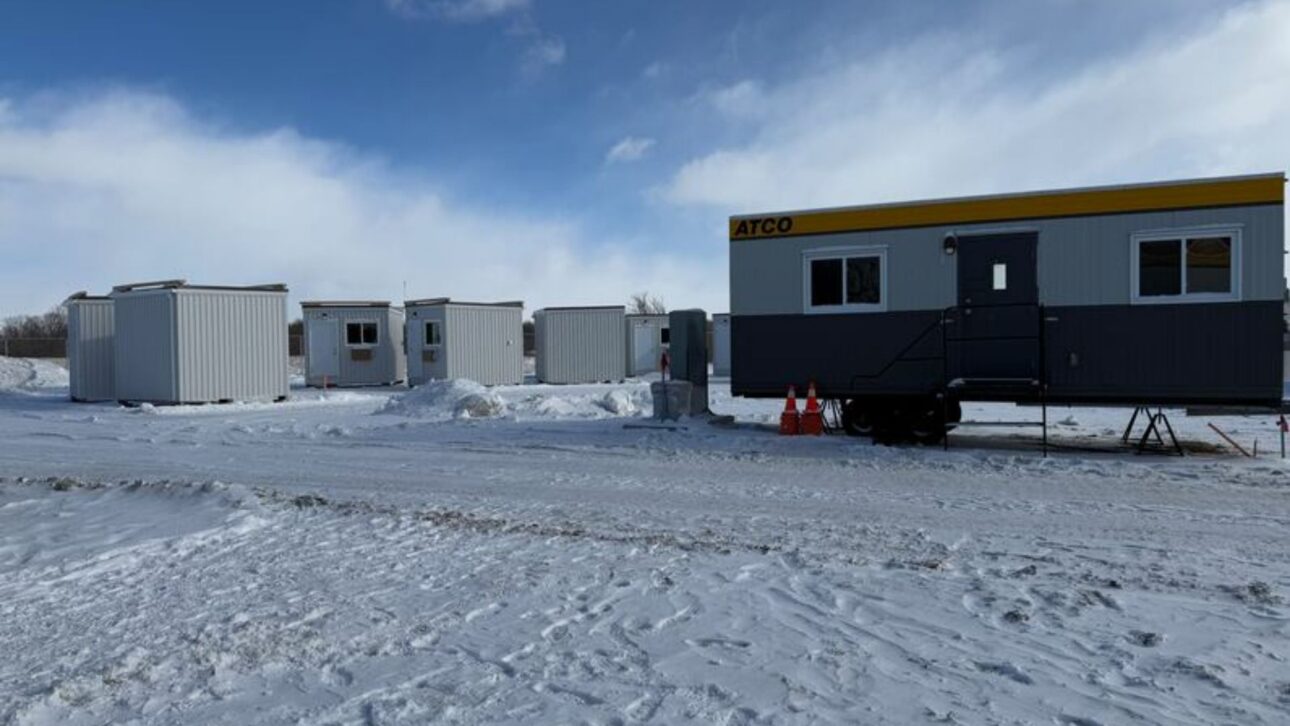 The common areas are located in large trailers and include a living area with sofa, table, and chairs. (Jack Sutton/CBC)