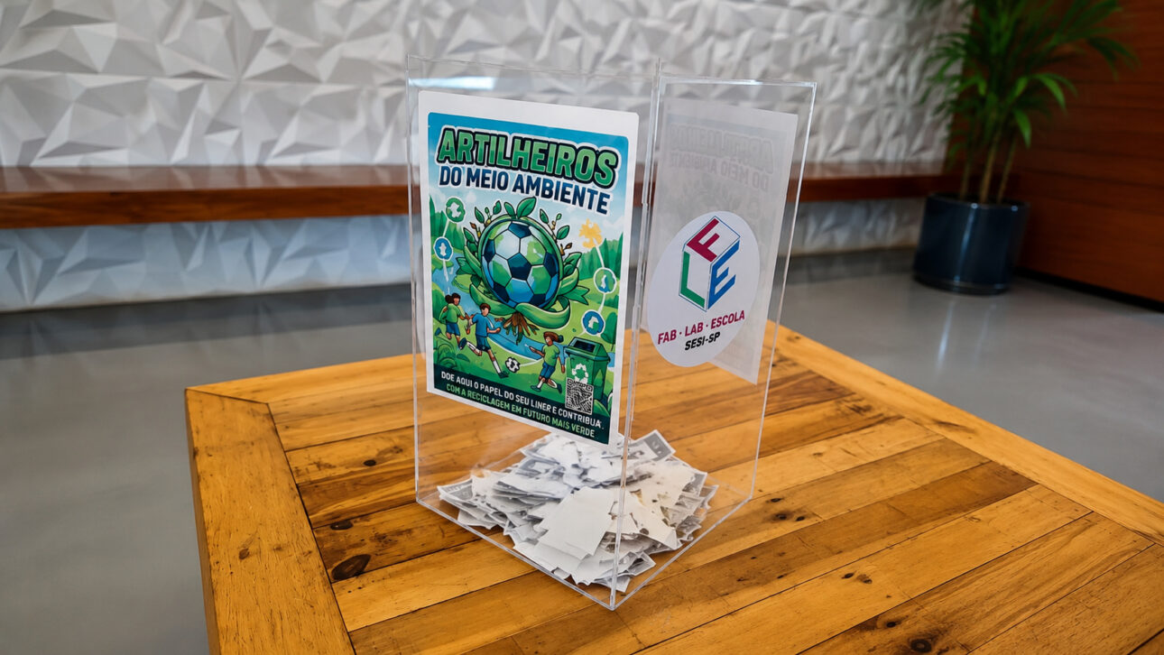Transparent collection box for recycling World Cup sticker paper positioned on a wooden table in a school environment, with waste stored for sustainable reuse.