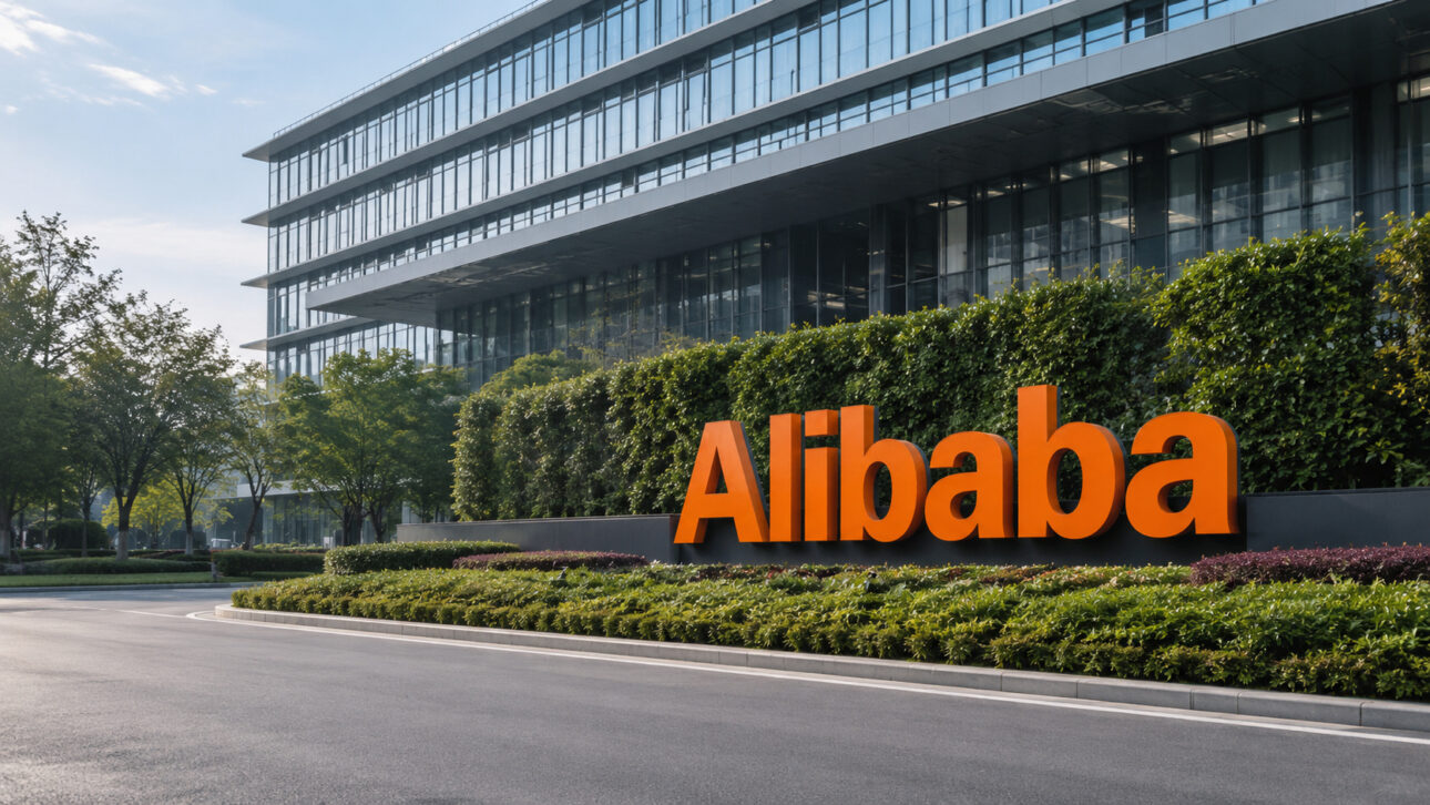 Modern facade of Alibaba with orange signage in a corporate area, representing the company's advancement in AI for robots and autonomous agents.