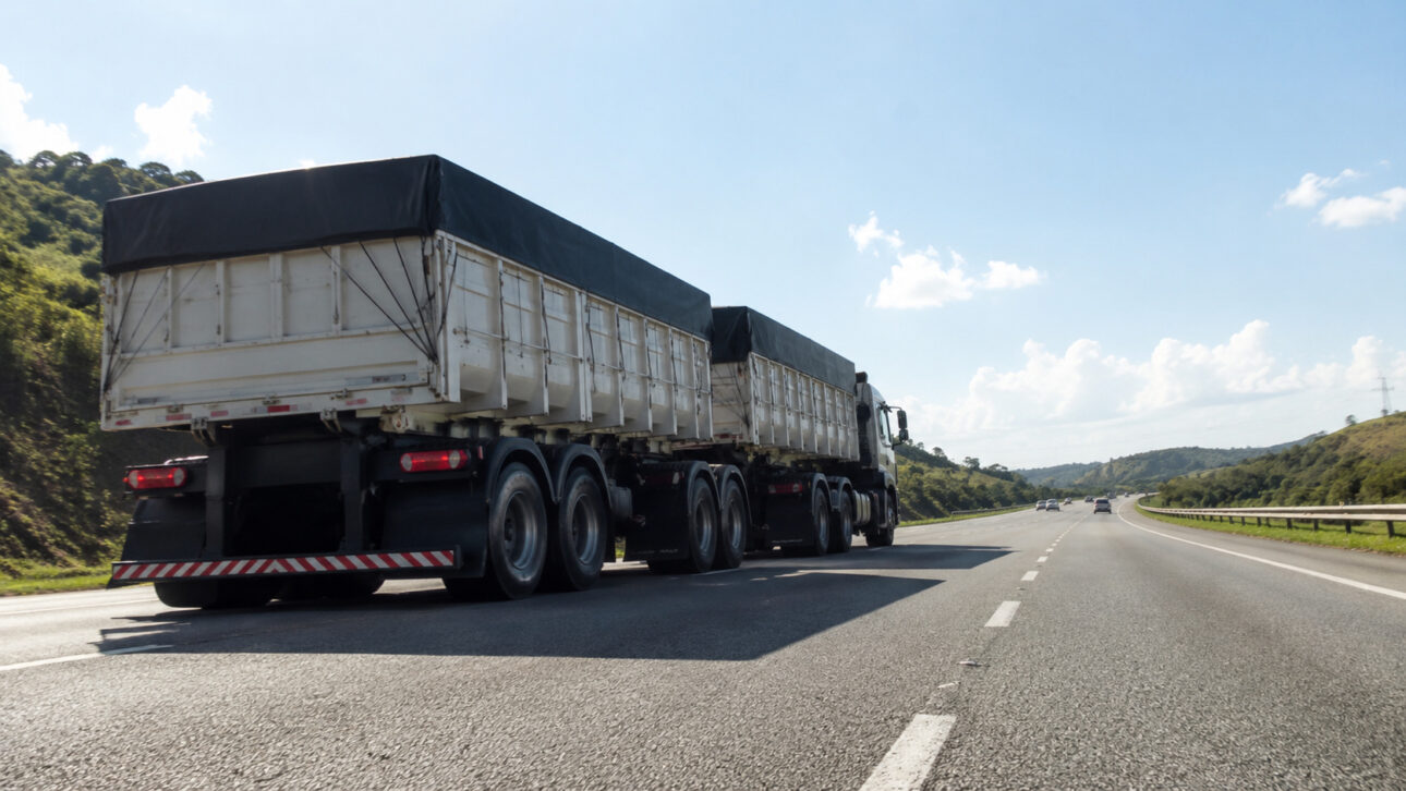 Cargo truck with a long trailer traveling on a highway during the day, representing road freight transport and long-distance freight.