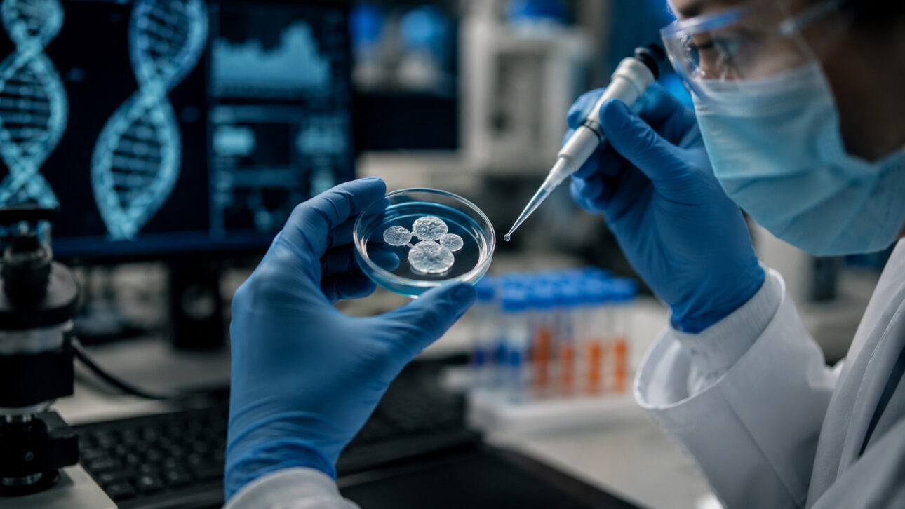 Researcher manipulates embryonic samples in the laboratory during a genetic editing experiment that seeks to correct mutations associated with hereditary diseases.