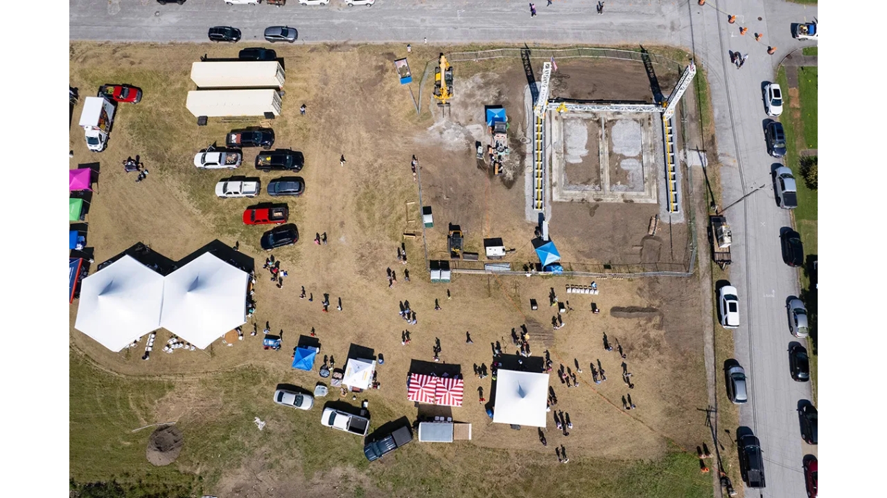 More than 100 people gathered to watch a huge 3D printer erecting the walls of the first house built in Cairo in 30 years. Photo: Julia Rendleman, Capitol News Illinois.