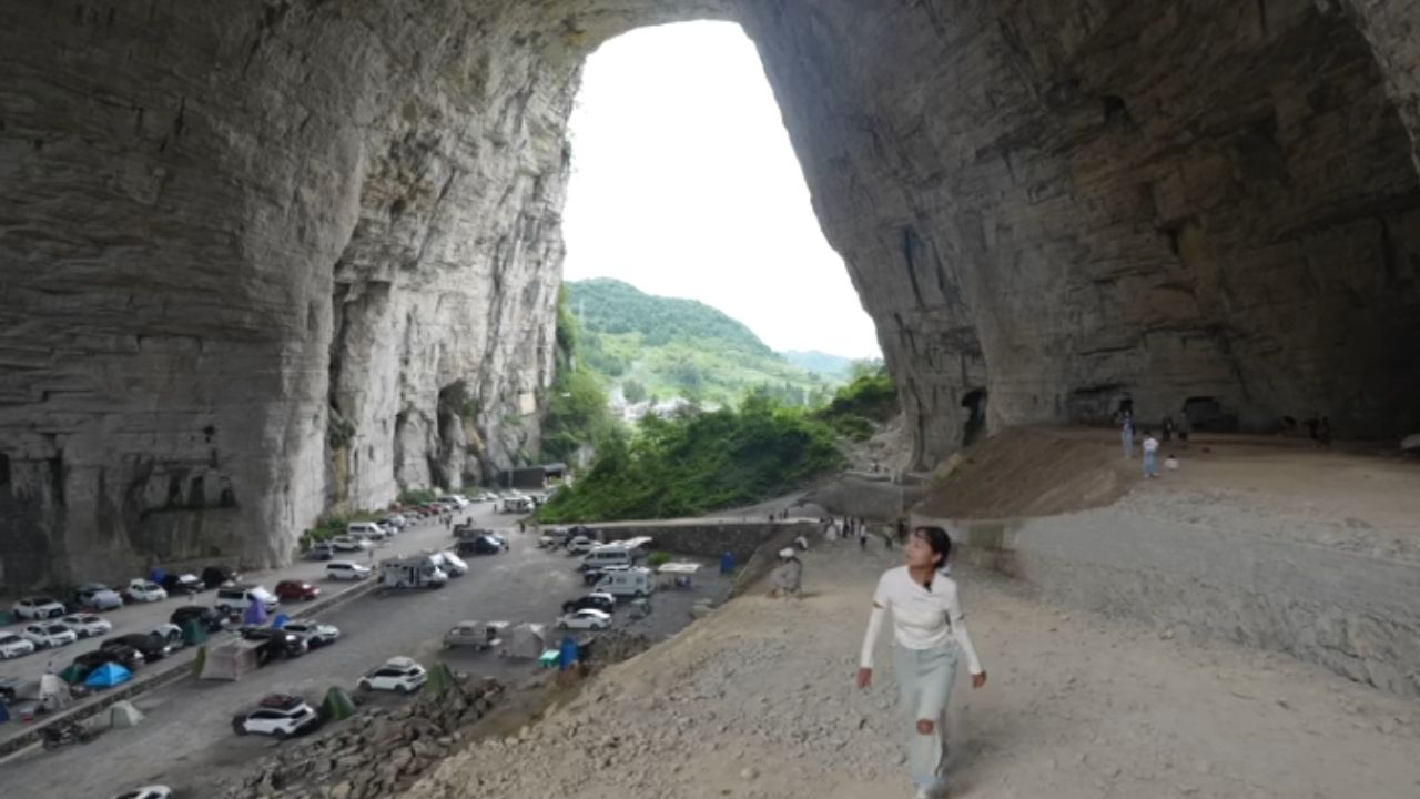 Qingxu Cave, in Guizhou, combines a natural bridge and giant karst formation with cars inside.