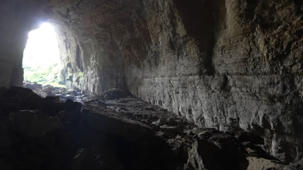 Qingxu Cave, in Guizhou, combines a natural bridge and giant karst formation with cars inside.
