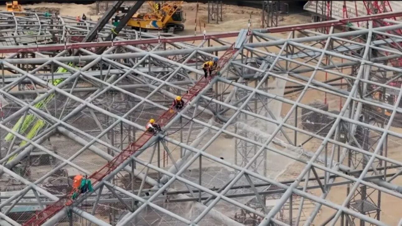 Welders, engineers, and heavy machinery operators work more than 40 meters above the ground
