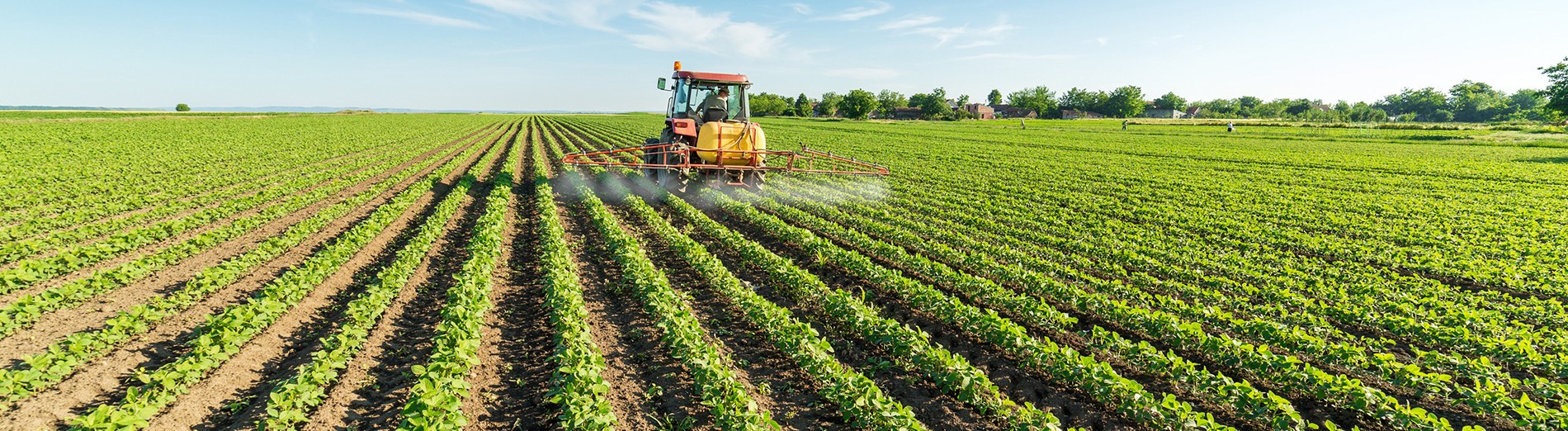 Tractor applying fertilizer in a field