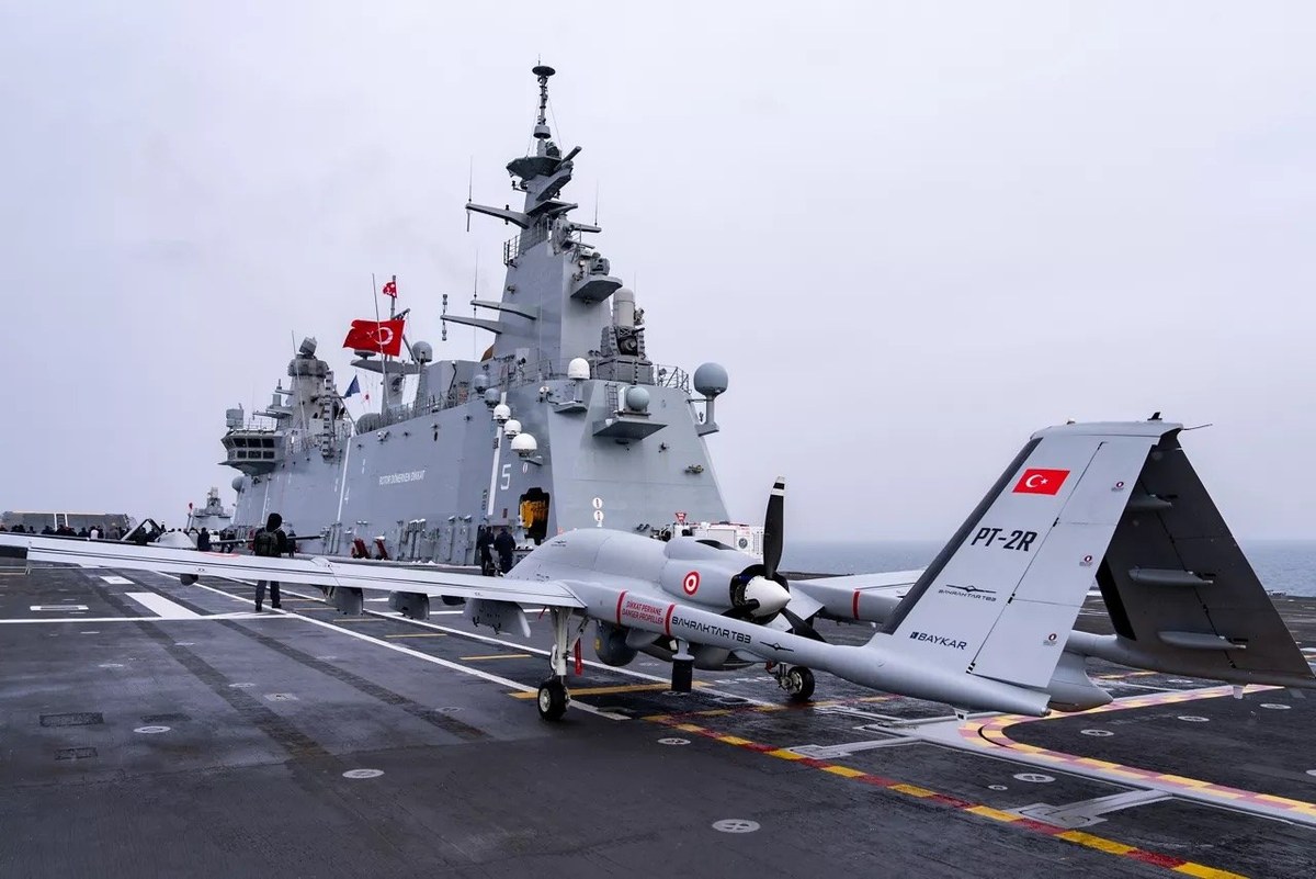 Warship with aircraft on deck in naval exercise