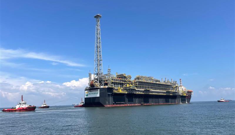 Oil platform in operation in the ocean at sunset