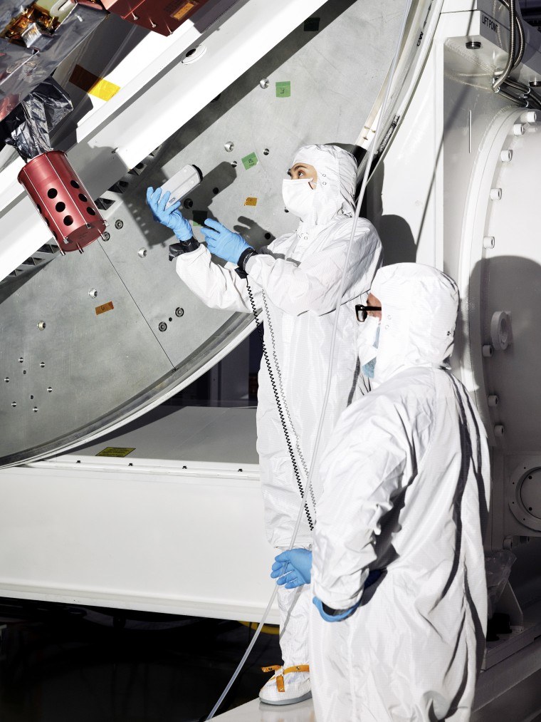 Técnicos preparando o telescópio Roman em sala limpa