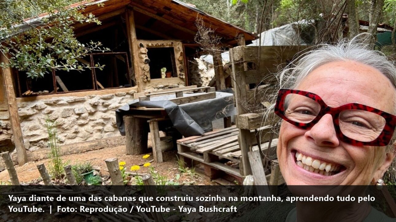 Yaya sorrindo diante da cabana que construiu (ótima)