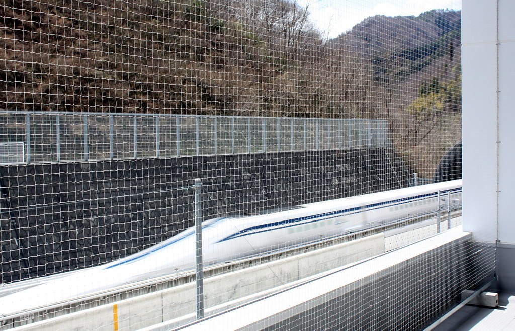 Japanese magnetic levitation train on a test track between mountains