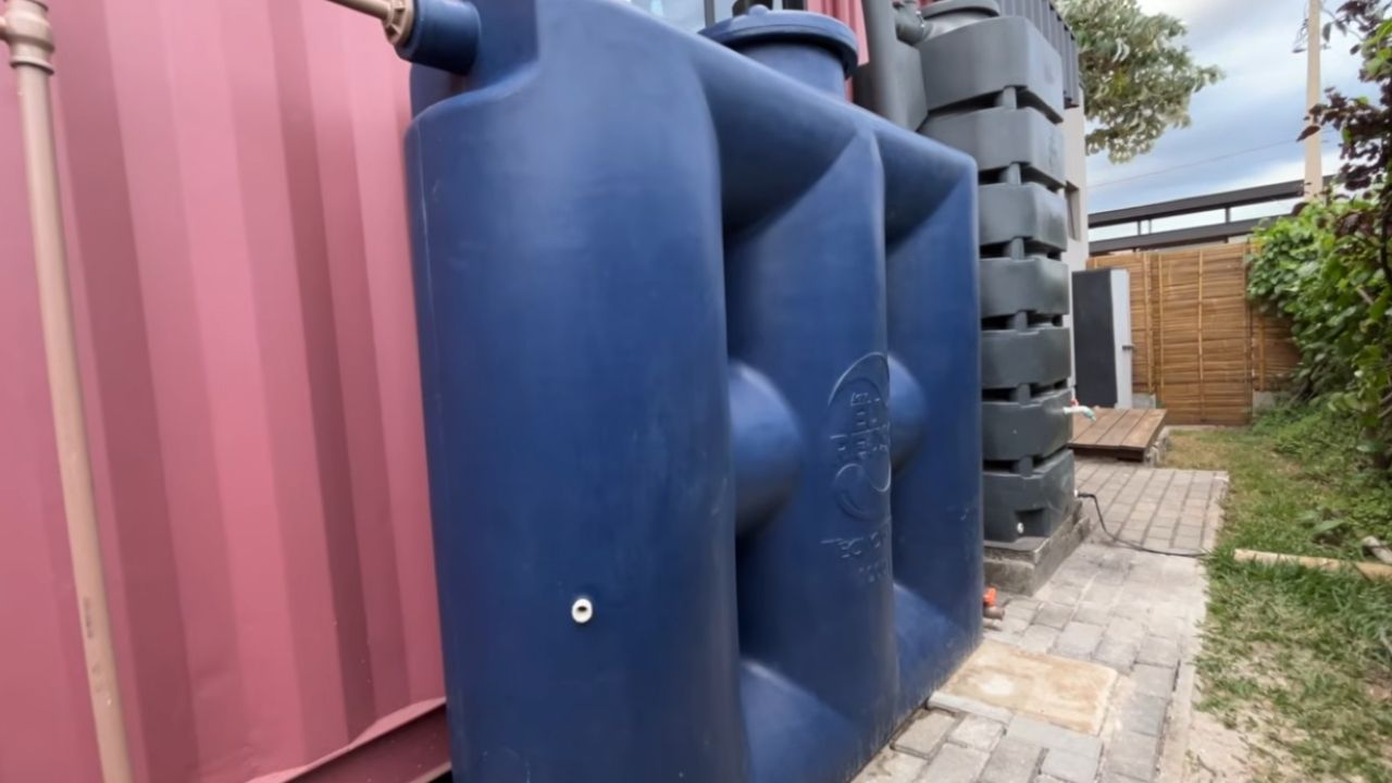 vertical cistern becomes water tank for potable water with reservoir and pressurizing pump in a compact house.