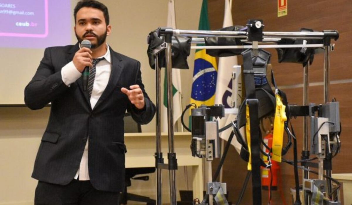 Matheus Soares Nascimento presents the exoskeleton prototype developed as a final project for the Electrical Engineering course at CEUB. Credit: Gabriel Telles/CEUB News Agency.