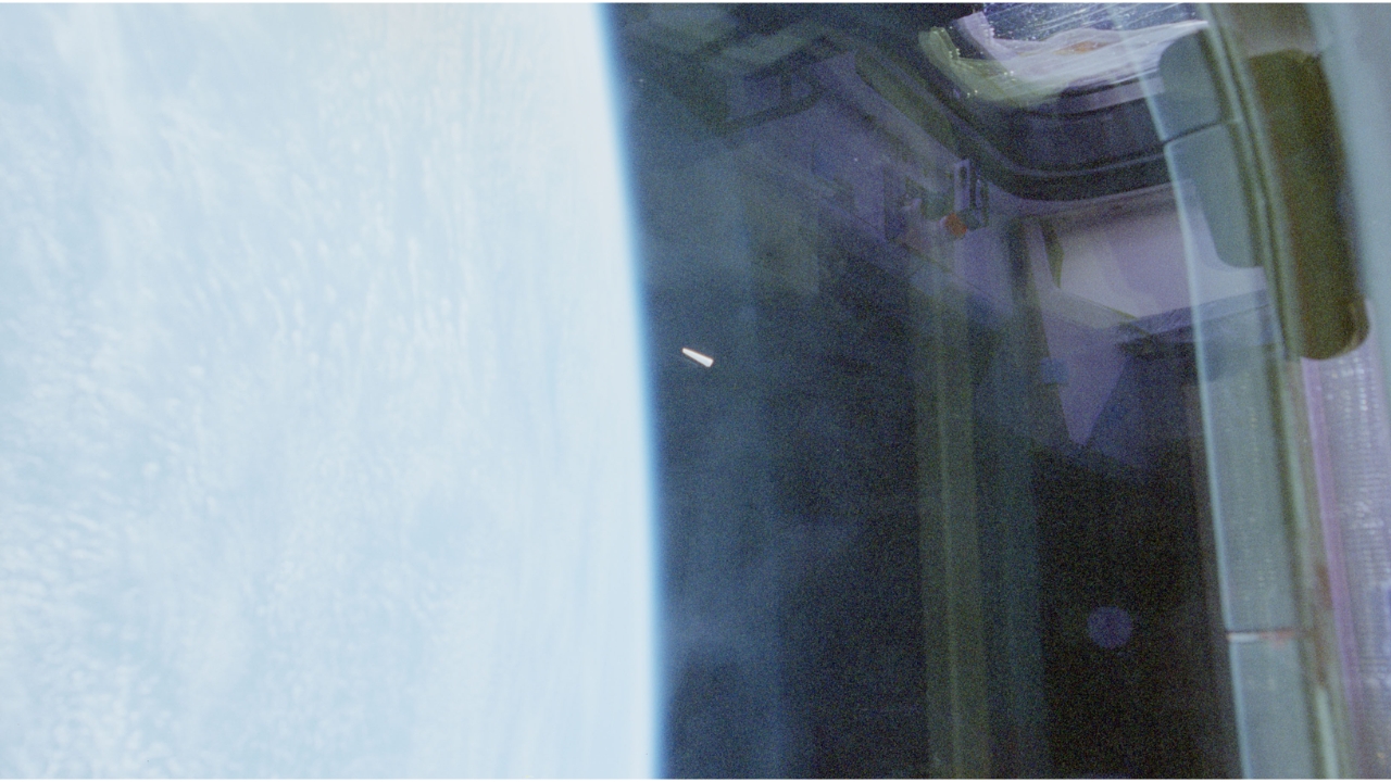 Unidentified object appears near the center of the image, to the right of the Earth's edge, in the first of three records made by astronauts aboard the Columbia space shuttle during the STS-80 mission, conducted between November 19 and December 7, 1996. Source: NASA/WAR.GOV/UFO.