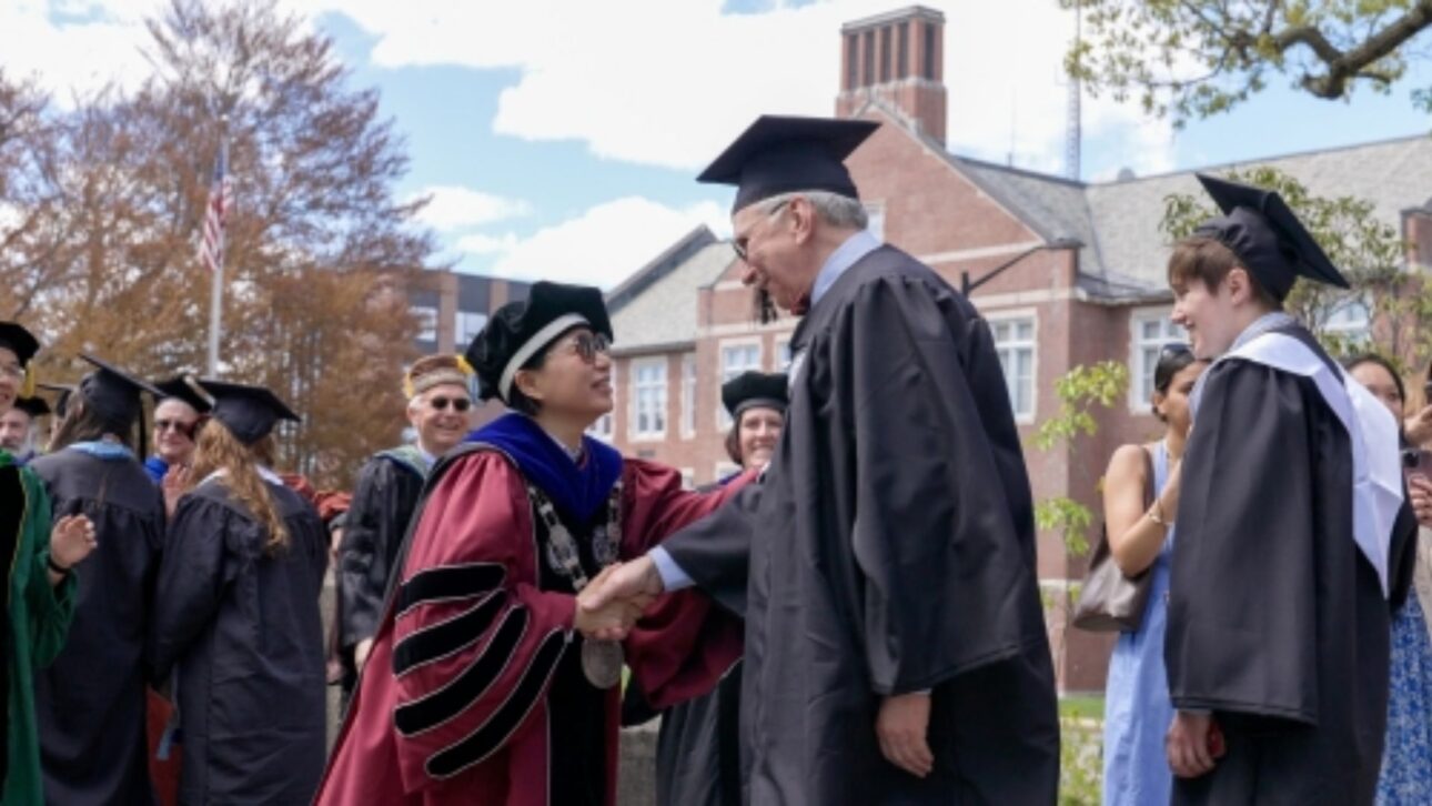 WPI President Grace Wang congratulates Kerry Lynn during the crossing of the Earle Bridge for the class of 2026.