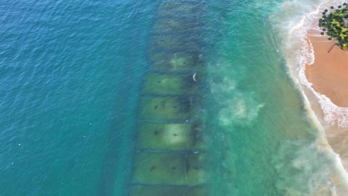 Submerged geotube breakwaters in Poonthura, seen during low tide