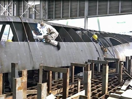 Welding on ship hull at shipyard