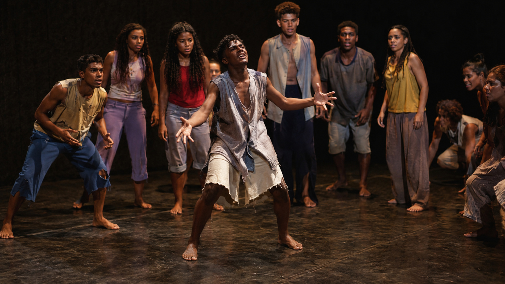 Jovens atores em apresentação teatral coletiva, representando o trabalho artístico desenvolvido pelo Nós do Morro no Vidigal.