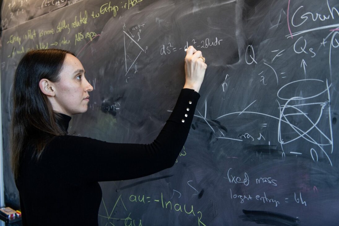 Sabrina Gonzalez Pasterski writes physics equations on a board after graduating from MIT with the highest GPA in the program.